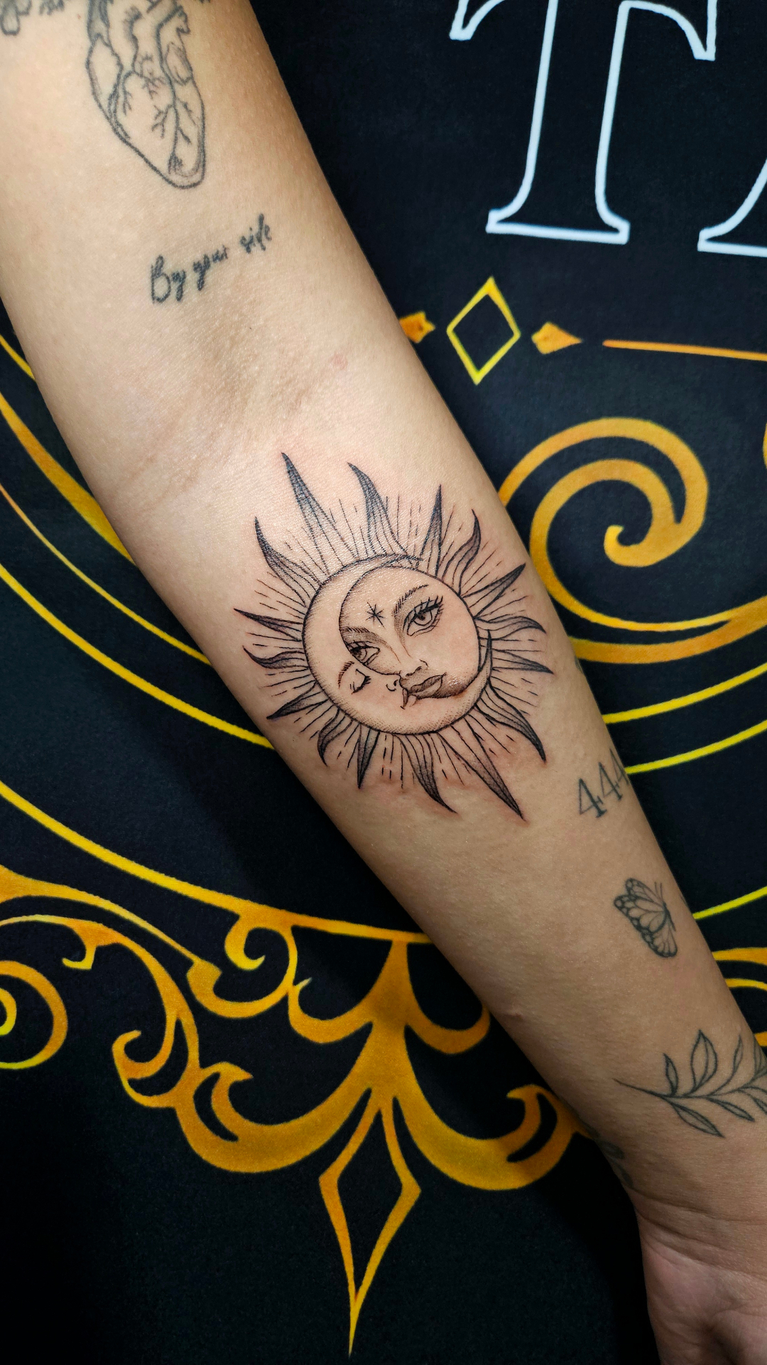 Tatuagem fineline botânica no antebraço, traço delicado em fundo claro